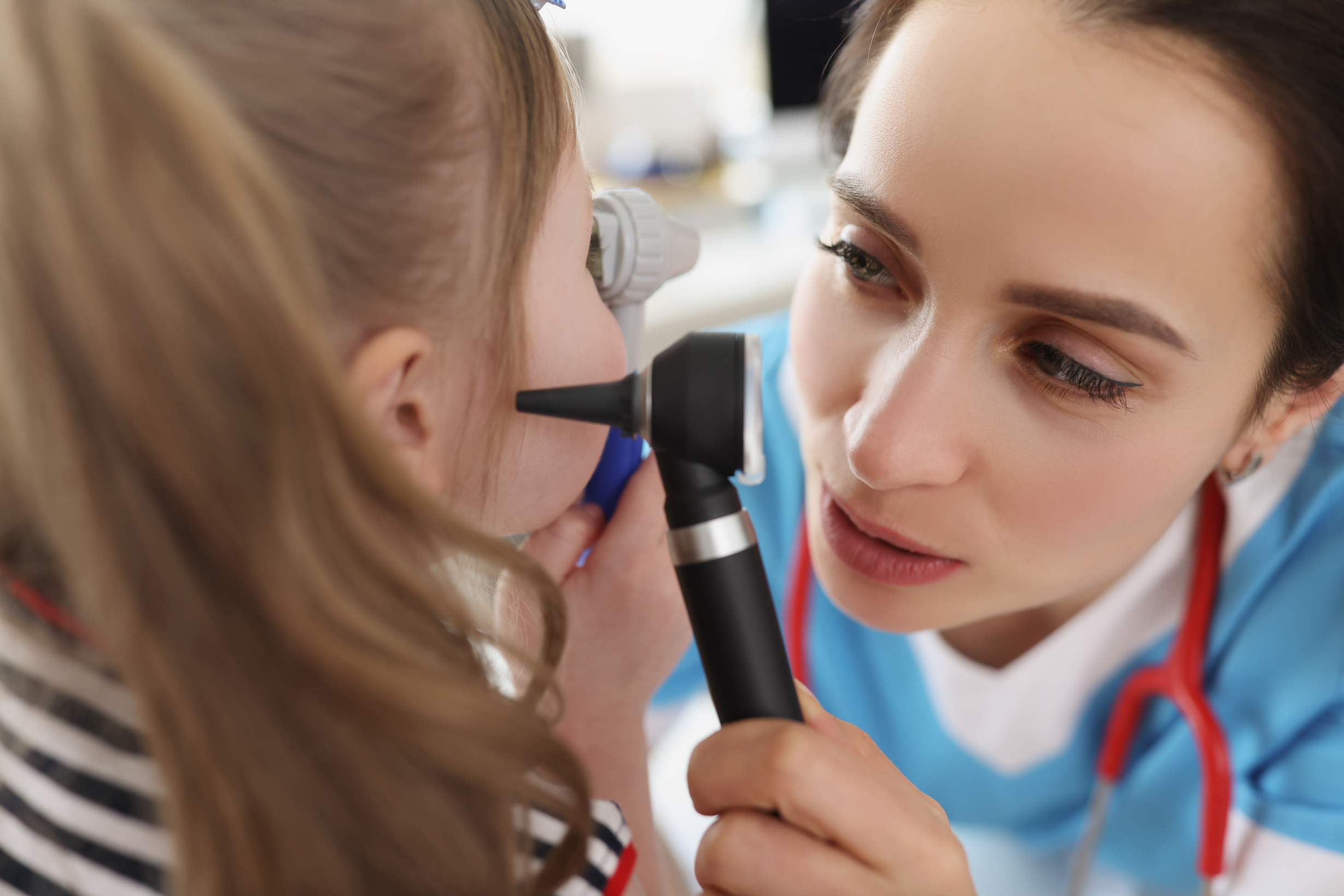 Otolaryngologist Examines Ear of Little Girl Patient